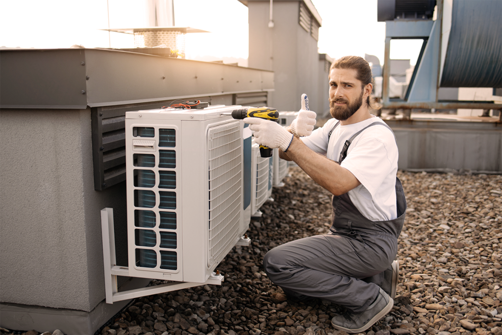 Heating and Air Conditioning Mid Sized HVAC Business Owner Servicing a Rooftop Unit