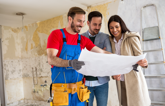 Construction Contractor Reviewing Plans with Clients