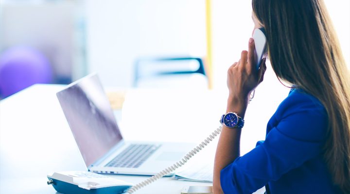 Woman in front of a computer understanding her call booking ratios